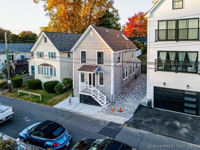 view of front of property with a balcony and a garage