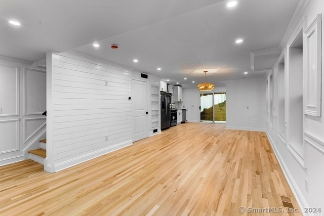 unfurnished living room with light hardwood / wood-style flooring