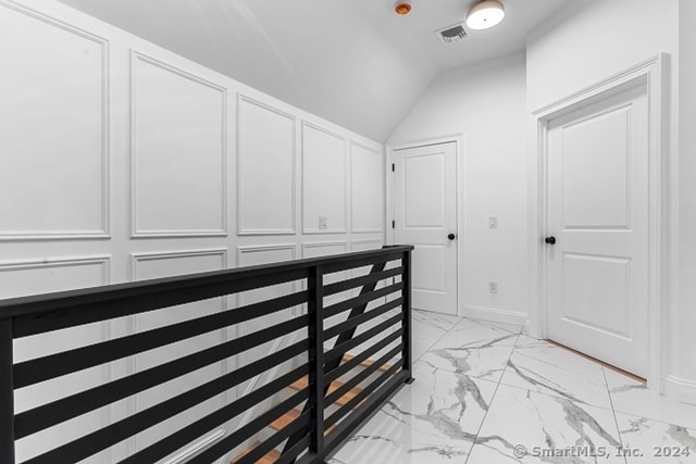 walk in closet featuring vaulted ceiling