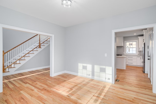 unfurnished room with light hardwood / wood-style floors