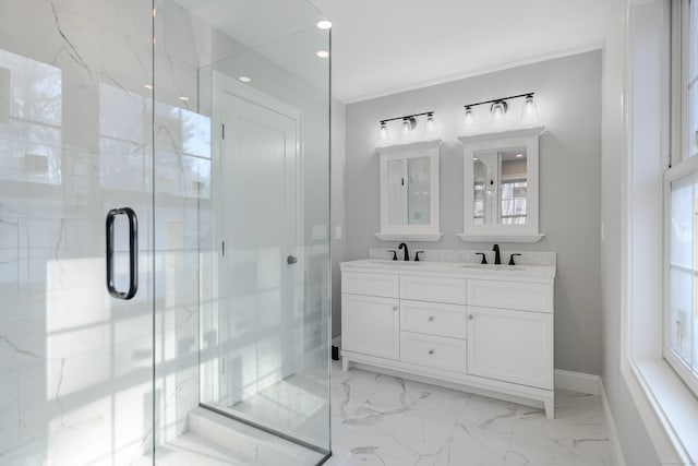 bathroom with vanity, a shower with door, and a wealth of natural light