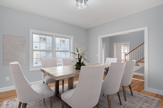 dining room with light hardwood / wood-style flooring and a wealth of natural light