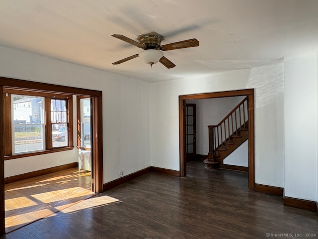 spare room with dark wood-type flooring and ceiling fan