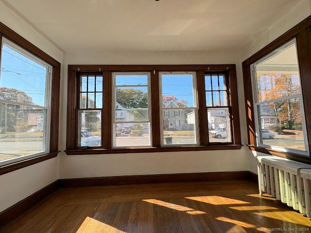 unfurnished sunroom featuring a wealth of natural light and radiator