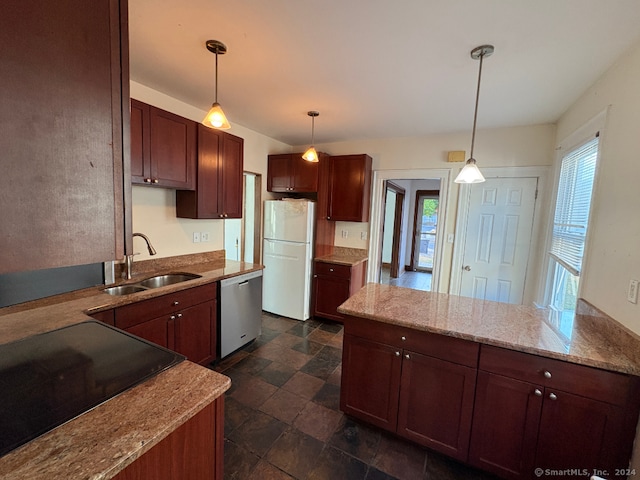 kitchen with black appliances, pendant lighting, a wealth of natural light, and sink