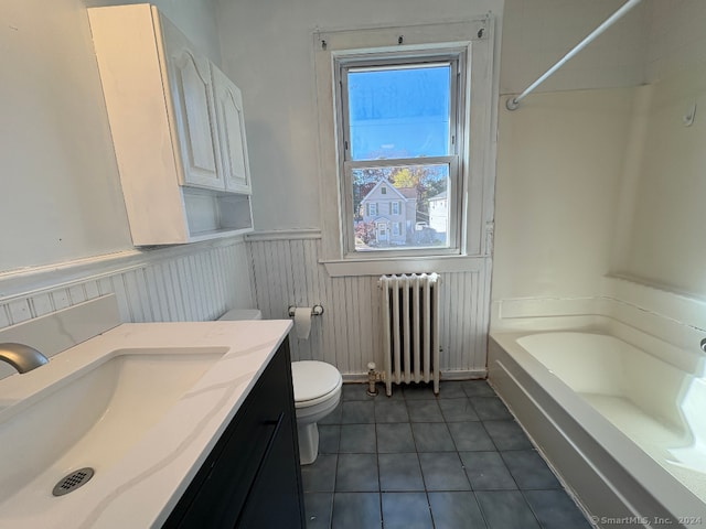 full bathroom featuring toilet, tile patterned floors, radiator, vanity, and bathing tub / shower combination