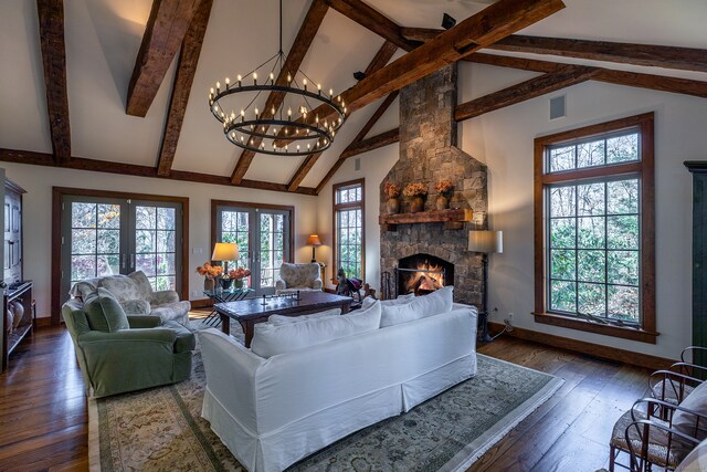 living room with a fireplace, plenty of natural light, and dark hardwood / wood-style floors