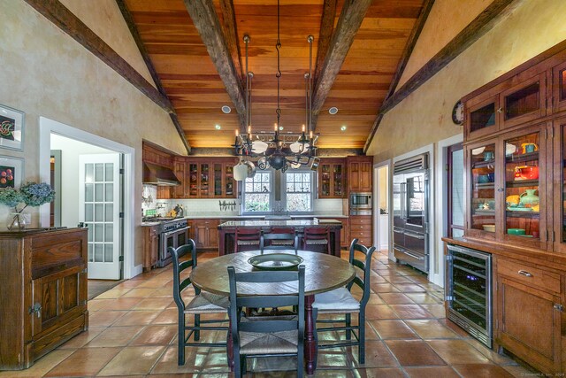 tiled dining room with beam ceiling, wine cooler, wood ceiling, and an inviting chandelier