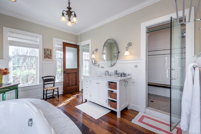 bathroom with a chandelier, shower with separate bathtub, hardwood / wood-style flooring, vanity, and ornamental molding