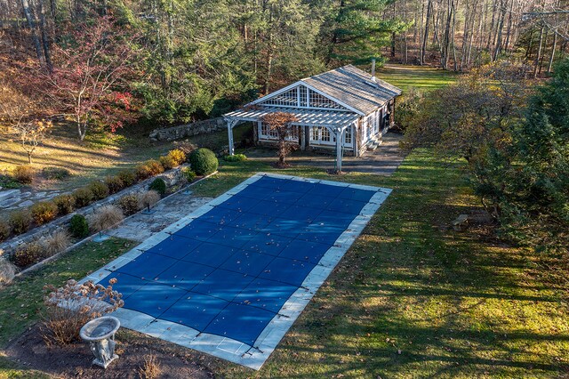 view of swimming pool featuring a patio area and a yard