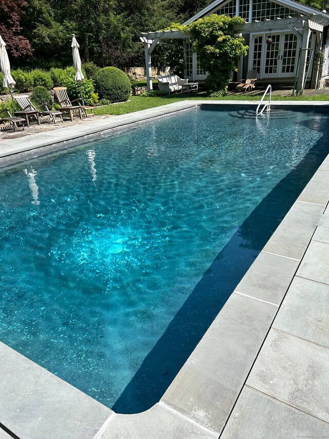 view of pool featuring french doors