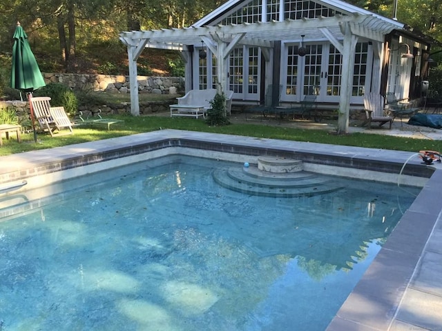 view of pool featuring french doors