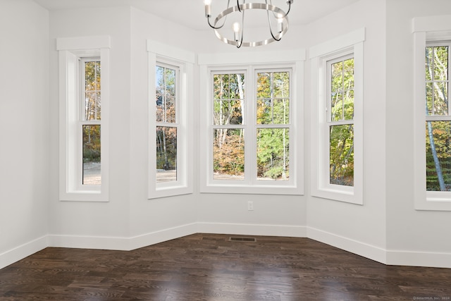 unfurnished sunroom featuring plenty of natural light and a chandelier