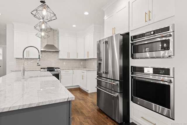 15 Parsons Way, Avon, CT 06001 - kitchen featuring stainless steel appliances, wall chimney exhaust hood, pendant lighting, dark wood-style flooring, and tasteful backsplash