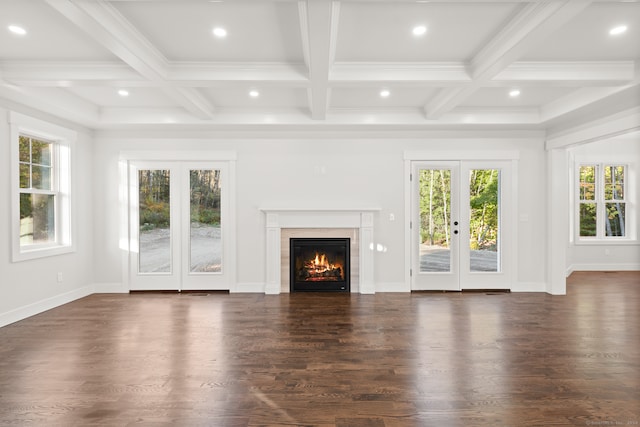 unfurnished living room with beamed ceiling, dark hardwood / wood-style floors, french doors, and coffered ceiling