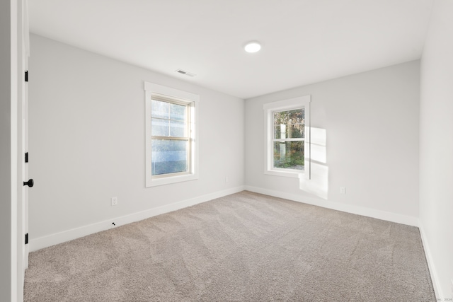 spare room with light carpet