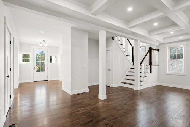 foyer entrance with a wealth of natural light, beam ceiling, and dark hardwood / wood-style flooring