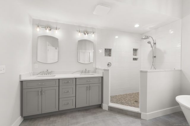 bathroom with independent shower and bath, vanity, and tile patterned floors