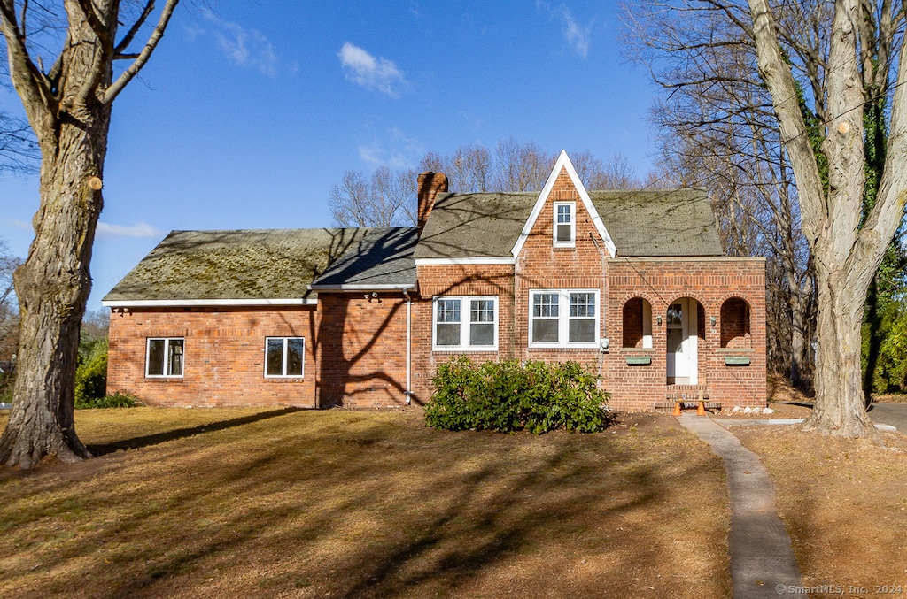 english style home with a front yard