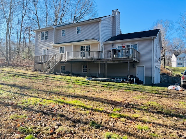 back of property with a yard and a deck