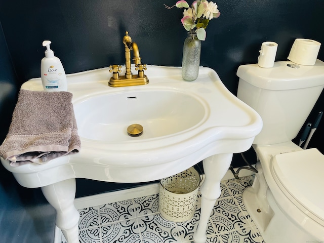 bathroom with toilet and tile patterned floors