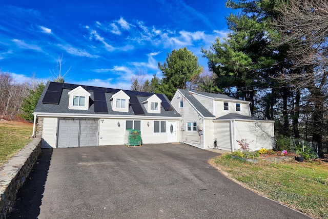 view of front of home with solar panels and a garage