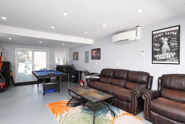 living room with a wall unit AC, concrete flooring, and pool table