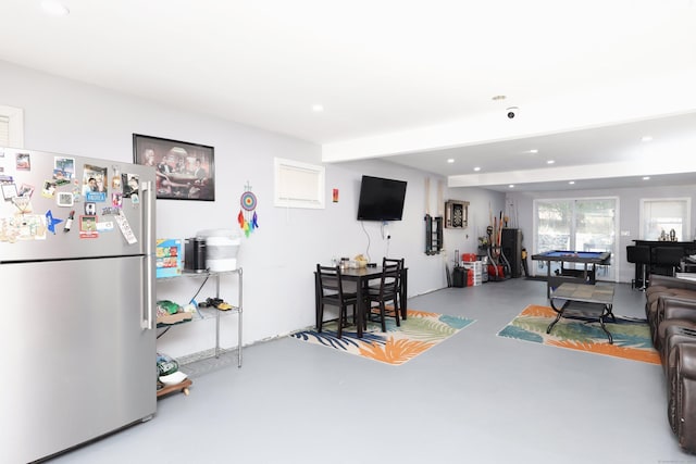 living room featuring concrete floors and billiards