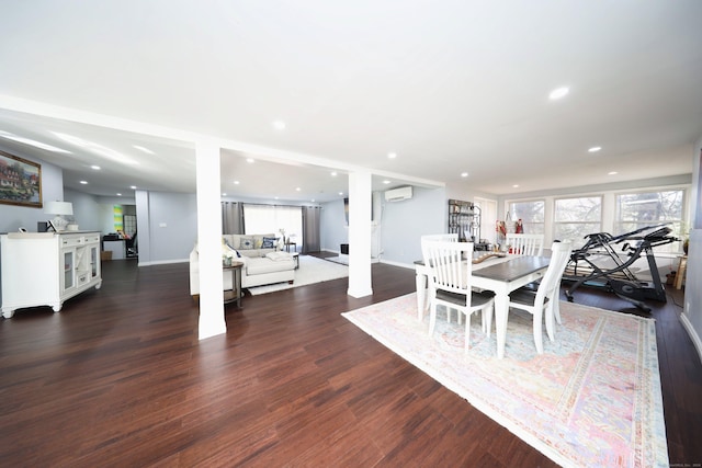 dining space featuring dark hardwood / wood-style floors and a wall unit AC