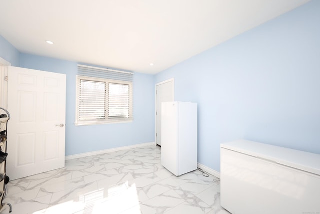 bedroom featuring white refrigerator and fridge