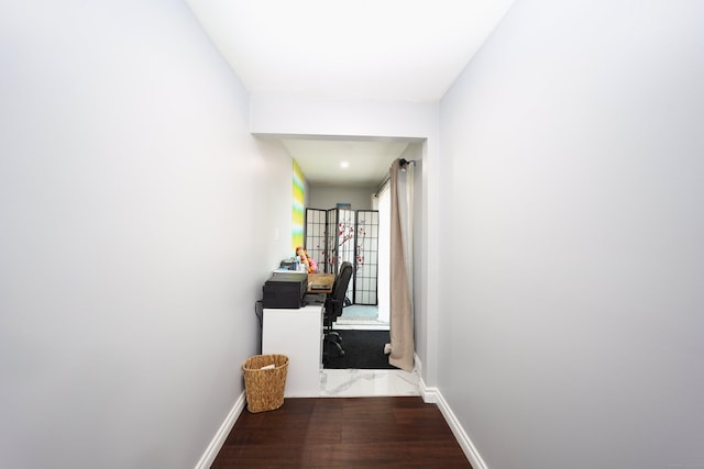 corridor with hardwood / wood-style floors