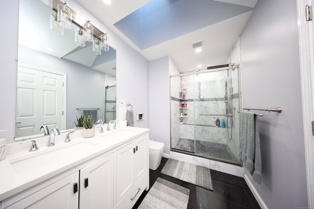 bathroom featuring tile patterned floors, vanity, toilet, and a shower with door