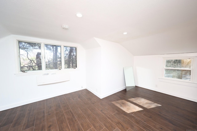 bonus room featuring dark hardwood / wood-style floors and vaulted ceiling