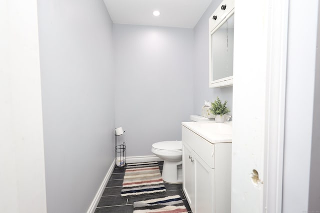 bathroom with vanity, hardwood / wood-style flooring, and toilet