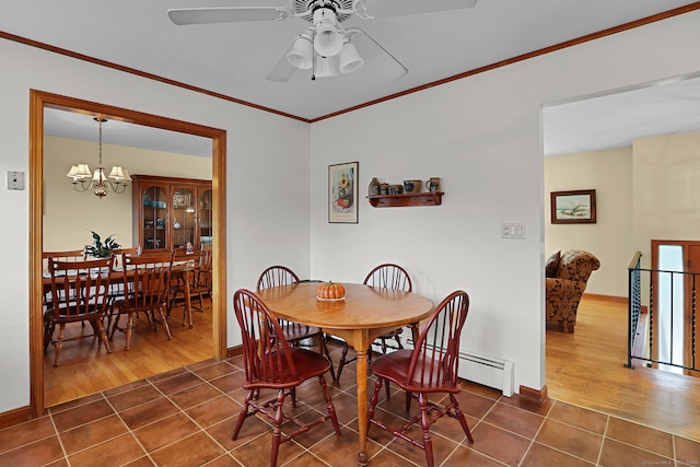 dining area with ceiling fan with notable chandelier, dark hardwood / wood-style flooring, and ornamental molding