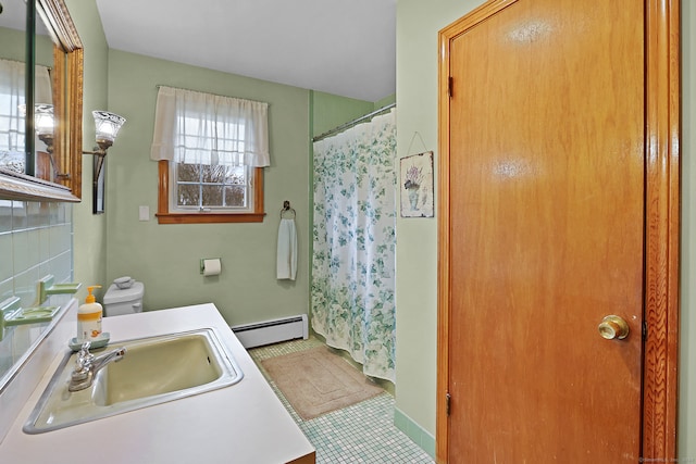 bathroom with toilet, tile patterned floors, baseboard heating, vanity, and backsplash