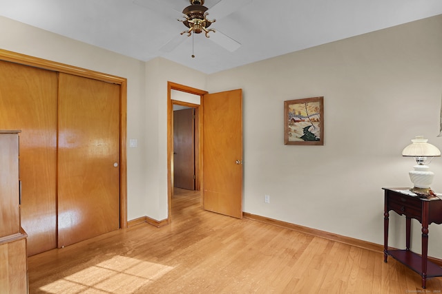 bedroom with ceiling fan, a closet, and light wood-type flooring