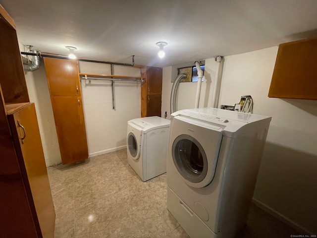 washroom with washing machine and clothes dryer