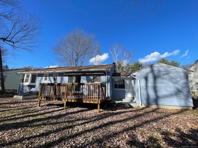 rear view of property featuring a deck