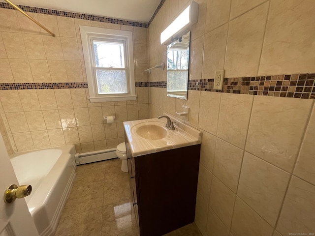 bathroom featuring baseboard heating, tile patterned floors, vanity, and tile walls