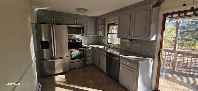 kitchen featuring gray cabinetry, sink, plenty of natural light, and appliances with stainless steel finishes