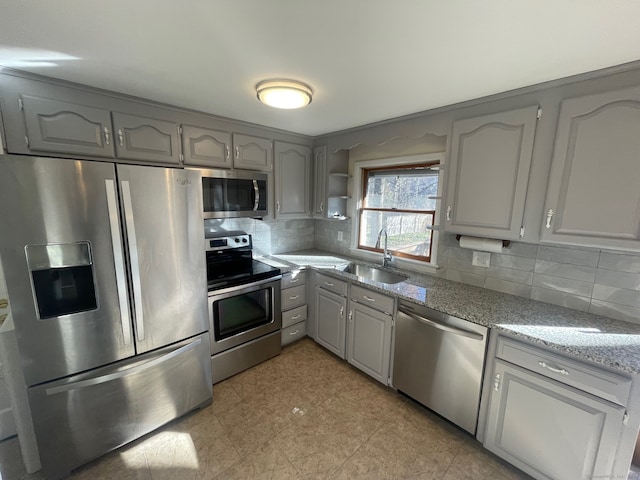 kitchen featuring gray cabinets, sink, and stainless steel appliances