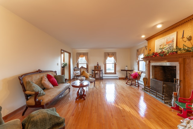 living room with hardwood / wood-style floors and a baseboard heating unit