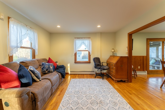 living room with light hardwood / wood-style floors and baseboard heating