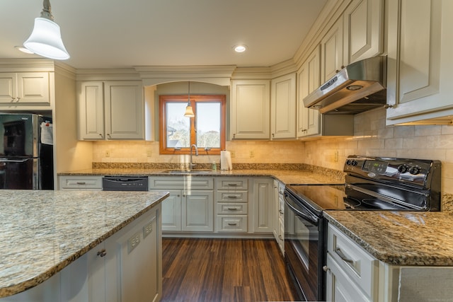 kitchen with sink, light stone counters, dark hardwood / wood-style flooring, pendant lighting, and black appliances