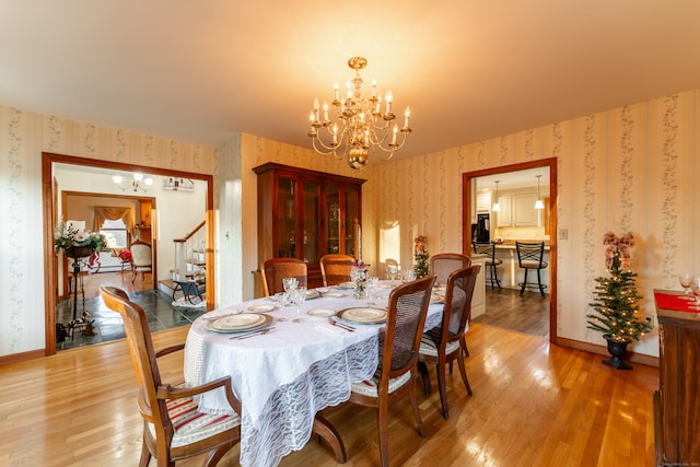 dining room with a chandelier and wood-type flooring