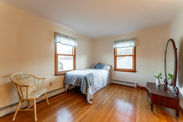 bedroom featuring wood-type flooring and baseboard heating