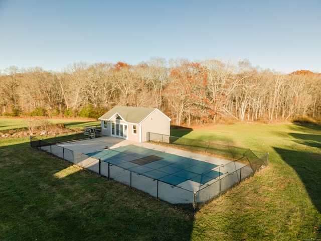 view of pool featuring a patio area, an outdoor structure, and a lawn