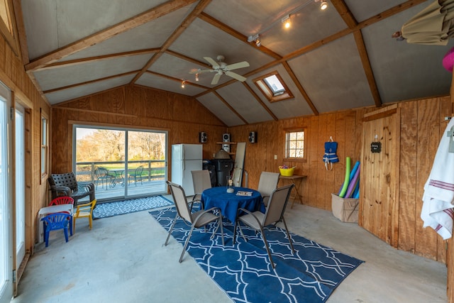 sunroom / solarium with a wealth of natural light, ceiling fan, and vaulted ceiling with skylight