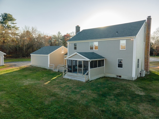 back of house with a sunroom and a lawn